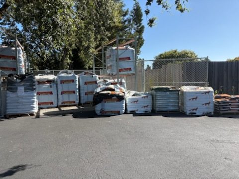 Pallets of bagged soil and growing media in the outdoor yard