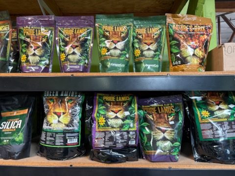 GreenGro Pride Lands organic fertilizer pouches on shelves